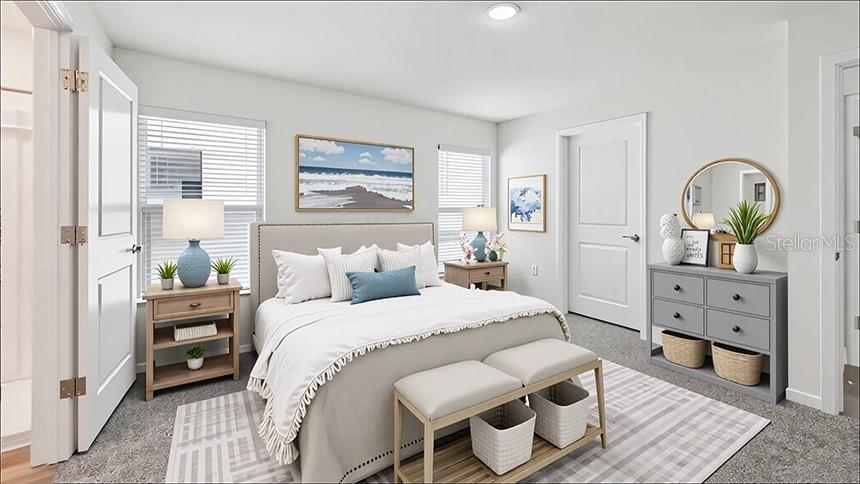 A bedroom features a bed with a light-colored quilt, two nightstands, and a gray dresser — 2094 NE 33RD LANE, OCALA, FL