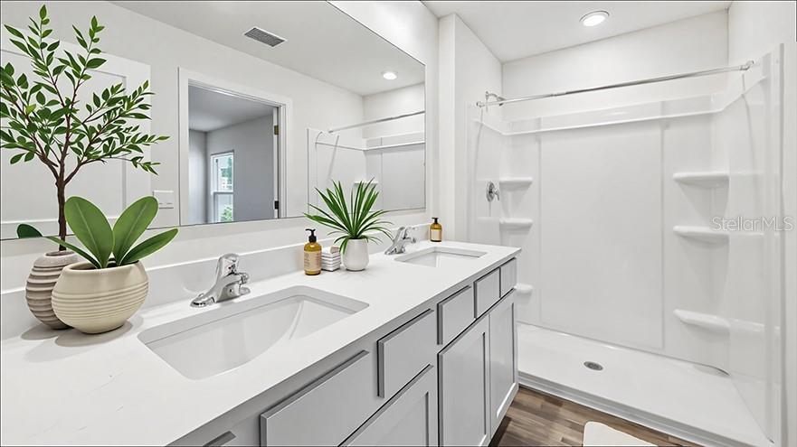 A modern bathroom features a white vanity with a sink, mirror, and walk-in shower — 2094 NE 33RD LANE, OCALA, FL