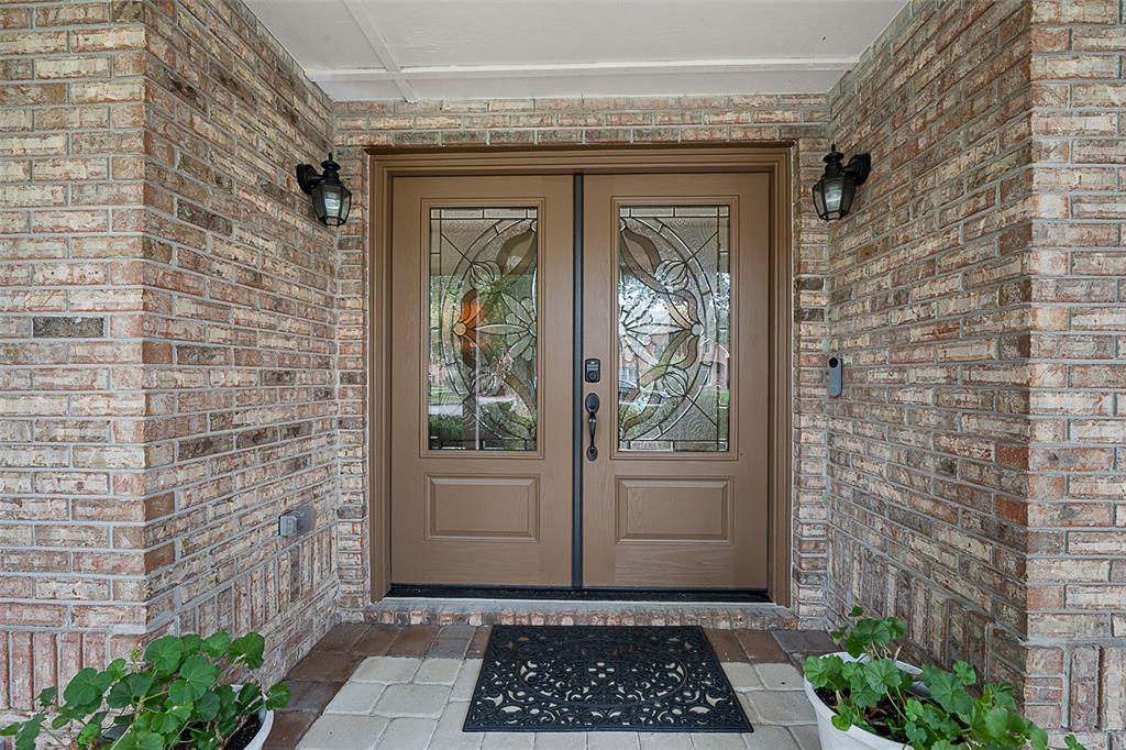 A two-story brick and siding house with a curved hedge-lined walkway and attached garage — 1 CROOKED BRIDGE WAY, ORMOND BEACH, FL