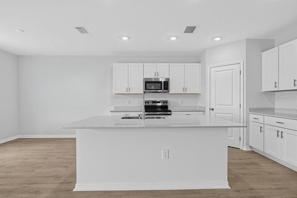 This is a floor plan for a single-story home featuring a garage, two bedrooms, and patio — 6753 EQUINOX LANE, NORTH FORT MYERS, FL