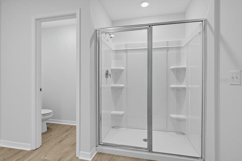 This design board displays samples of luxury vinyl plank, carpet, white cabinets, and quartz countertops — 6753 EQUINOX LANE, NORTH FORT MYERS, FL