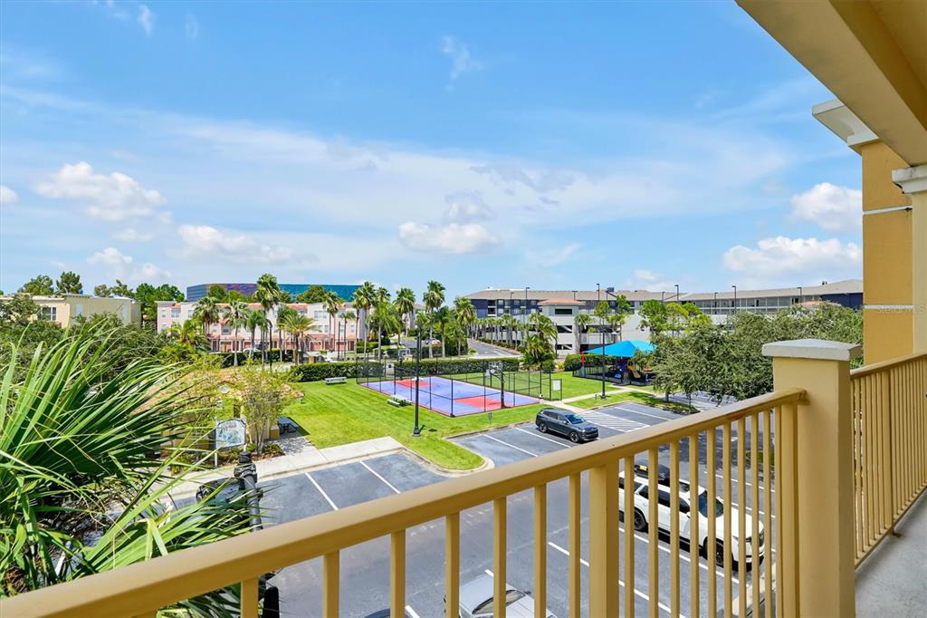 A view from a balcony overlooking a parking lot, a basketball court, and apartment buildings — 5025 SHOREWAY LOOP UNIT 30403, ORLANDO, FL