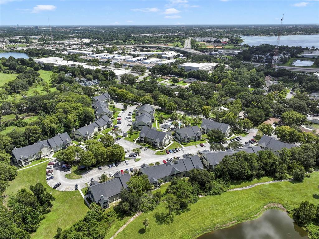 An aerial view shows a multi-building apartment complex surrounded by trees and a small pond — 3721 S LAKE ORLANDO PARKWAY UNIT 6, ORLANDO, FL