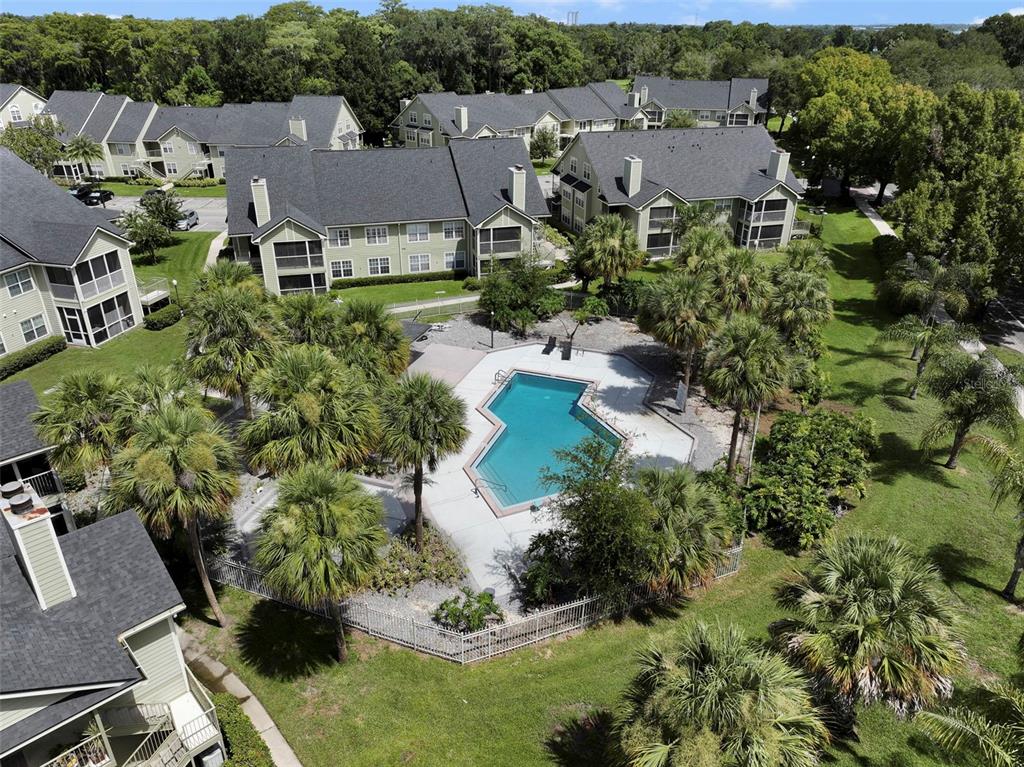 An aerial view shows a swimming pool surrounded by palm trees and apartment buildings — 3721 S LAKE ORLANDO PARKWAY UNIT 6, ORLANDO, FL