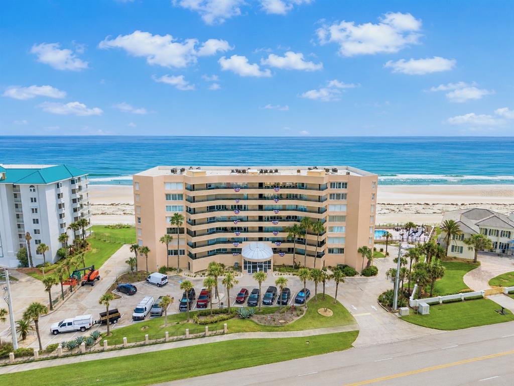 An aerial view of a beachfront condominium complex with a swimming pool and sandy beach — 4651 S ATLANTIC AVENUE UNIT 9203, PONCE INLET, FL