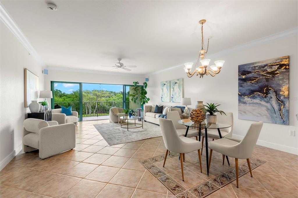 A gated entrance with a paved driveway leads to a multi-story building with palm trees — 1695 PINELLAS BAYWAY S UNIT D1, TIERRA VERDE, FL