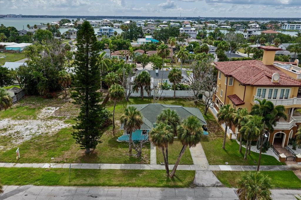 An aerial view shows a turquoise house next to a large, multi-story tan villa — 835 BRUCE AVENUE, CLEARWATER BEACH, FL