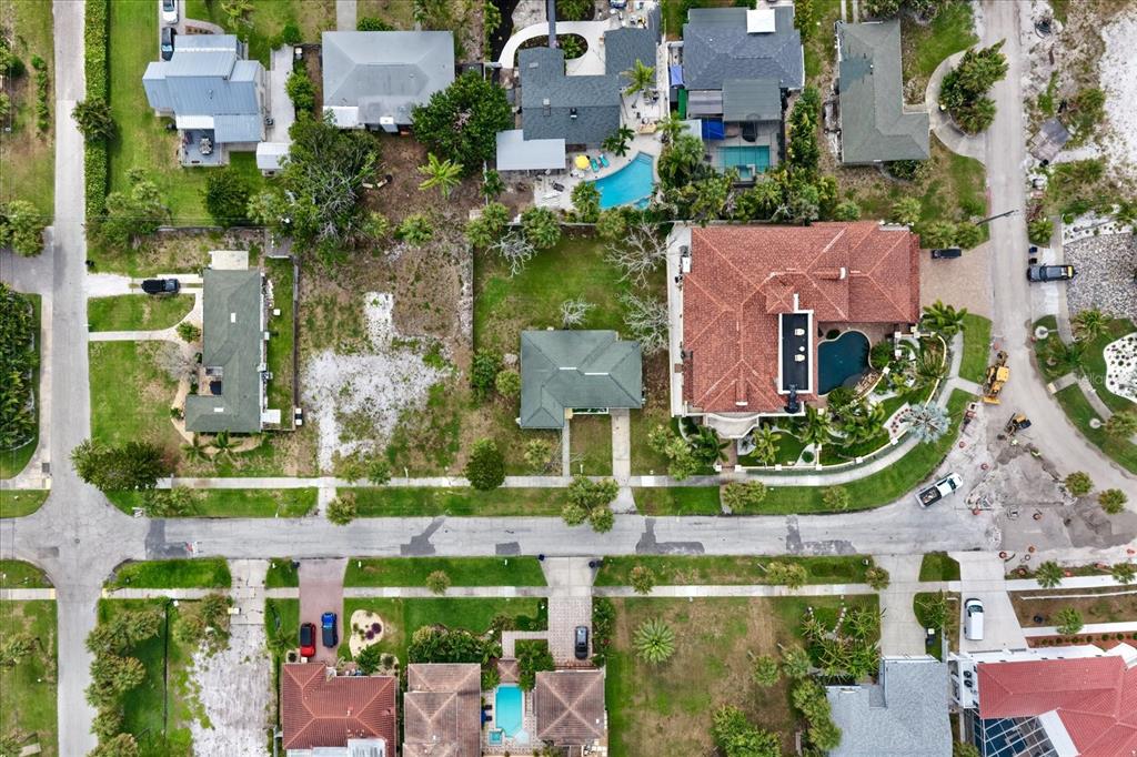 An aerial view shows several residential houses with pools and a vacant lot — 835 BRUCE AVENUE, CLEARWATER BEACH, FL