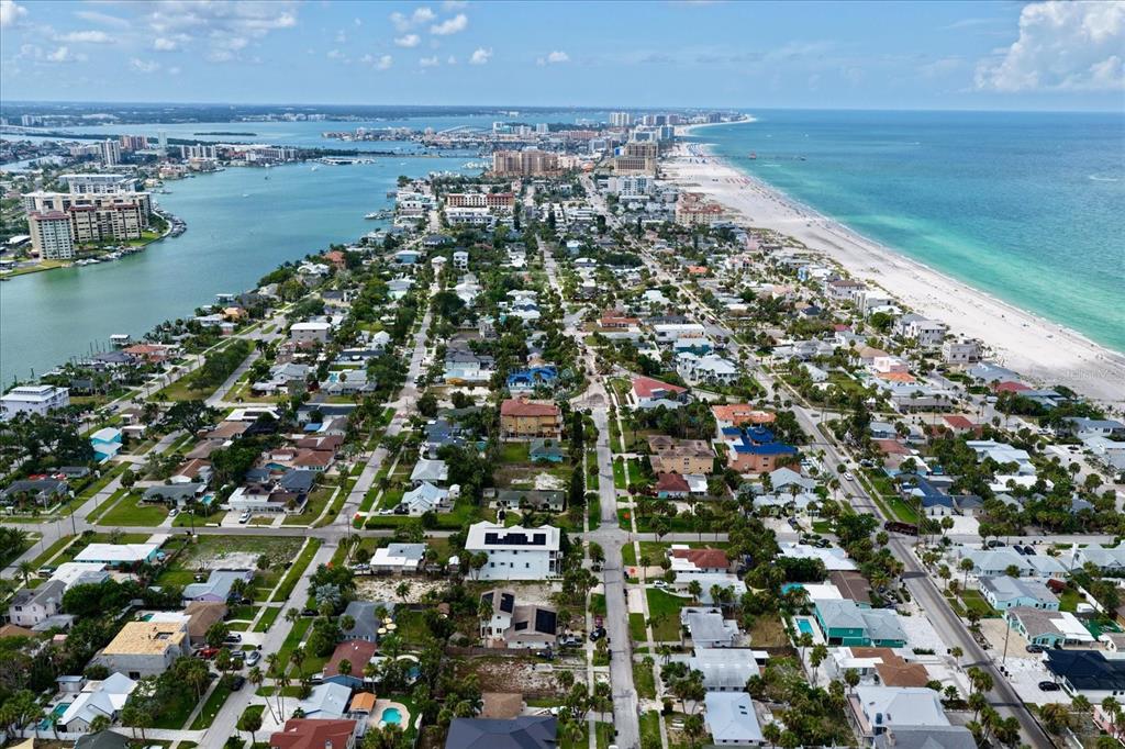 An aerial view of a coastal residential neighborhood situated between a bay and the ocean — 835 BRUCE AVENUE, CLEARWATER BEACH, FL