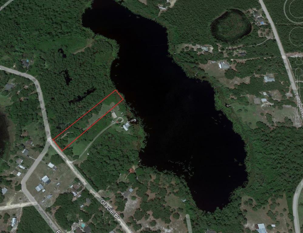 An aerial map view shows a rectangular property lot outlined in red bordering a lake — 0 Gracie DRIVE, PAISLEY, FL
