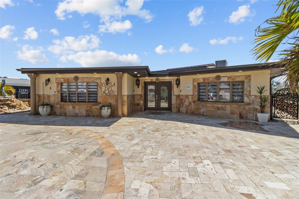 An aerial view of a waterfront house with a pool, deck, and private boat lift — 357 LA HACIENDA DRIVE, INDIAN ROCKS BEACH, FL