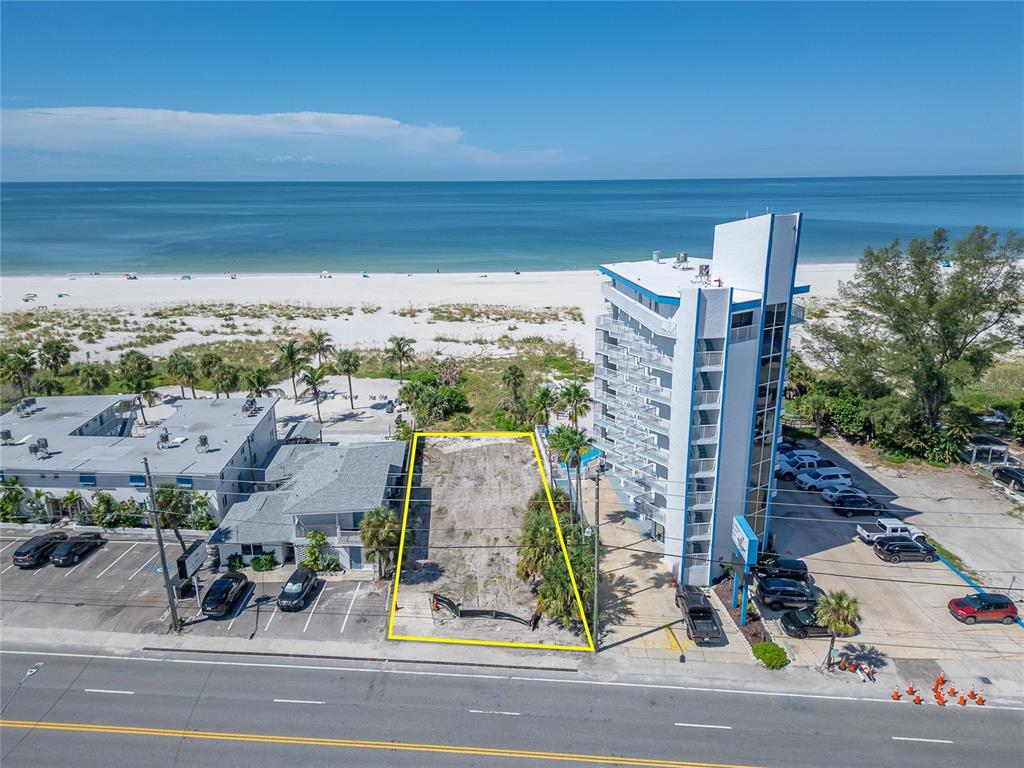 An elevated view of a sandy beach with palm trees and a private pool area — 10178 GULF BOULEVARD, TREASURE ISLAND, FL