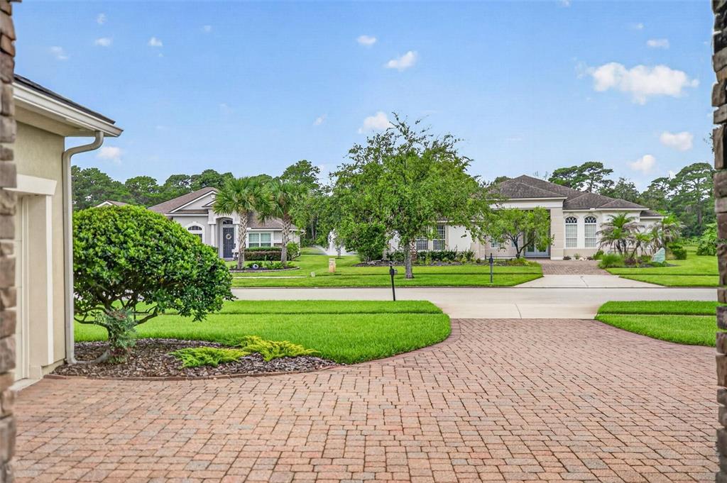 A view from a paved driveway looking across a street toward two suburban houses — 533 CHRISTINA DRIVE, ST AUGUSTINE, FL