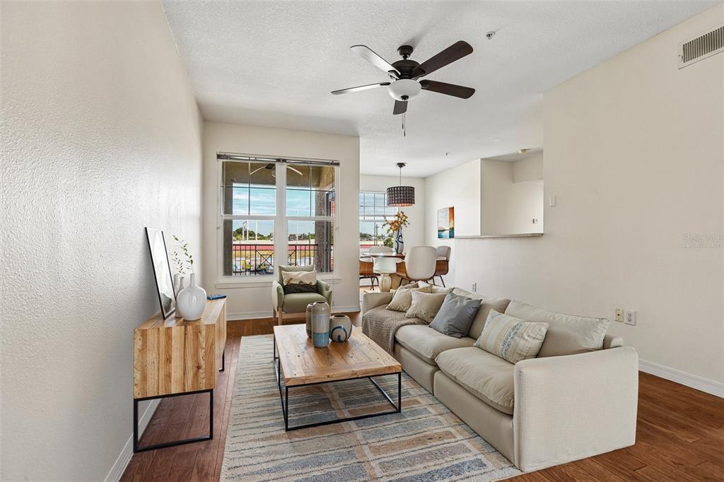 A living room with wood-look flooring, a ceiling fan, a sofa, and a television — 1810 E PALM AVENUE UNIT 5322, TAMPA, FL