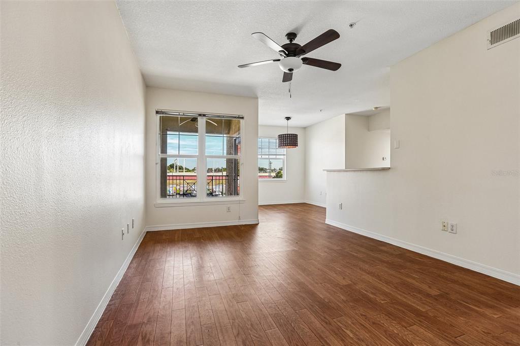 A balcony features two red chairs, a small table, and a view of a parking lot — 1810 E PALM AVENUE UNIT 5322, TAMPA, FL