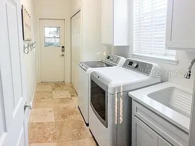 A laundry room features a washer, dryer, utility sink, and tile flooring — 250 KILLARNEY, WINTER PARK, FL