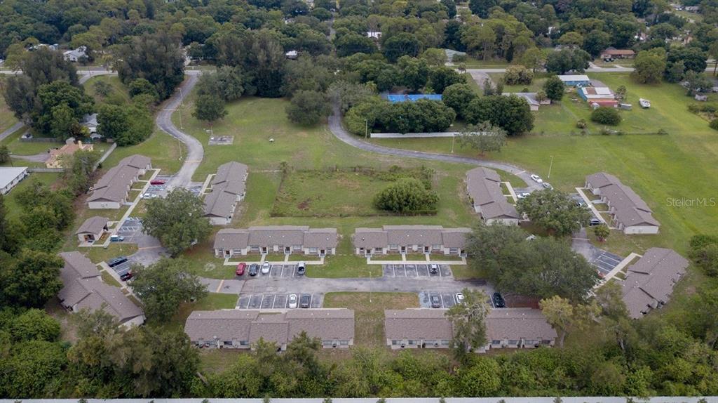 An aerial view shows a residential complex with multiple single-story buildings and parking lots — 709 OCEANSIDE CIRCLE UNIT 753, RUSKIN, FL