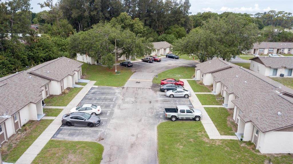 An aerial view shows two rows of single-story apartment buildings with a shared parking lot — 709 OCEANSIDE CIRCLE UNIT 753, RUSKIN, FL