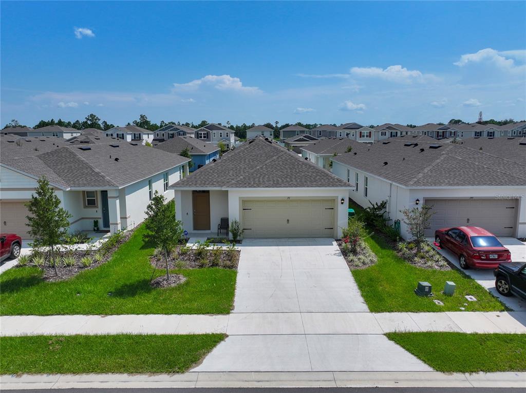 A single-story suburban house with a two-car garage and a concrete driveway — 191 AMBERWOOD WAY, UMATILLA, FL