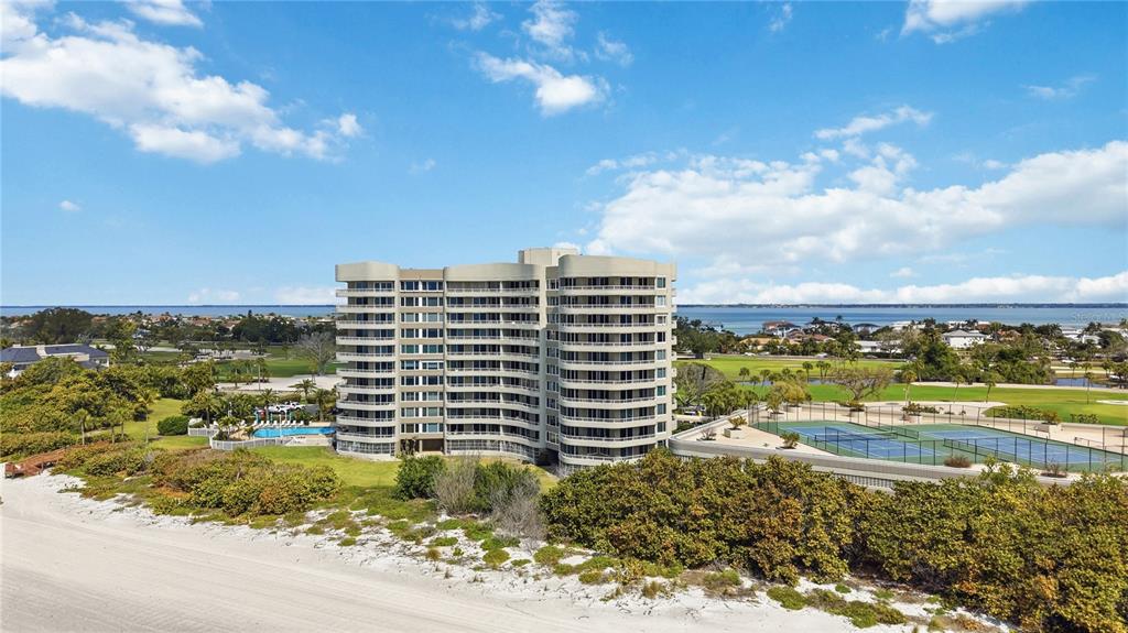A balcony with a white railing overlooks a sandy beach and the ocean — 775 LONGBOAT CLUB ROAD UNIT 401, LONGBOAT KEY, FL