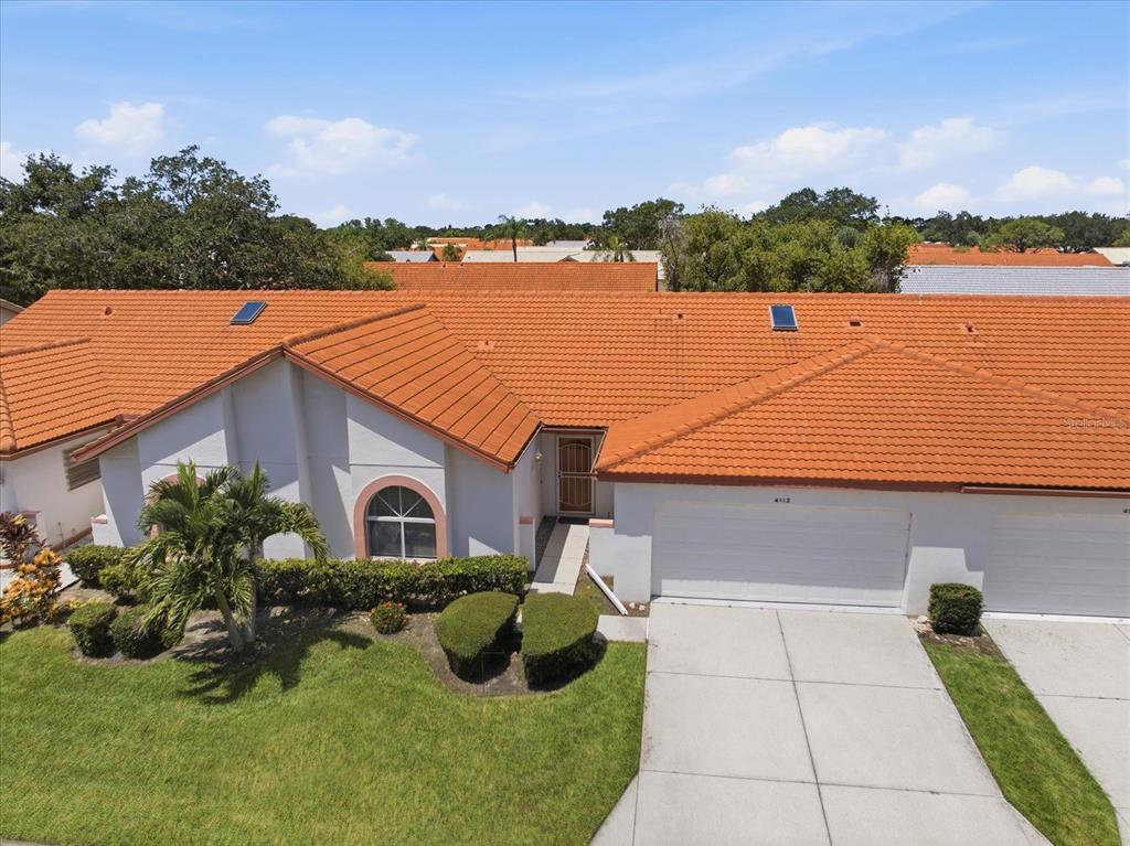 An aerial view of a single-story house with a terracotta tile roof and garage — 4112 VALLARTA COURT UNIT 3041, SARASOTA, FL