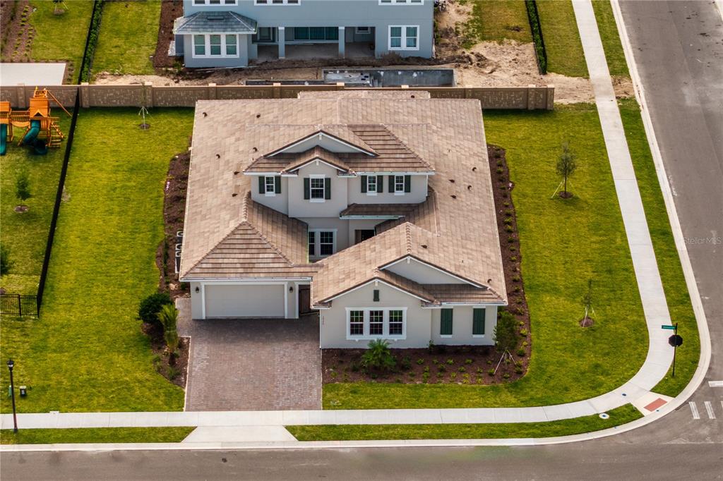 An aerial view of a two-story suburban house with a tiled roof and paved driveway — 10176 BROCKSPORT CIRCLE, GOTHA, FL