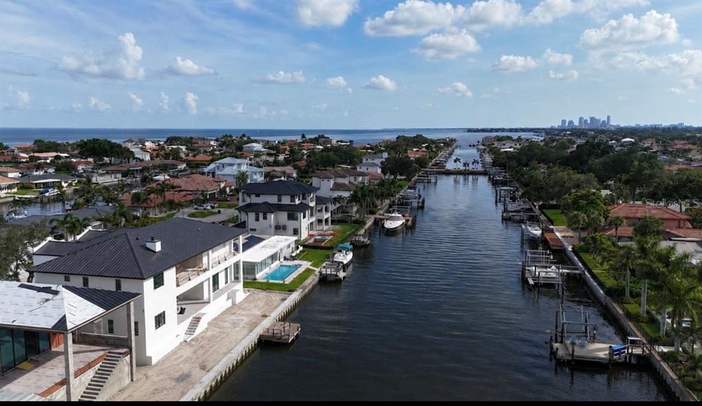 An aerial view of waterfront homes with private docks along a canal leading to the bay — 2051 ILLINOIS AVENUE NE, ST PETERSBURG, FL