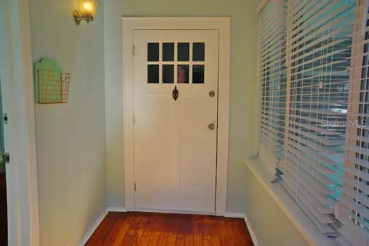 An entryway with hardwood floors, a white door with glass panes, and a window — 601 N OSCEOLA AVENUE, CLEARWATER, FL
