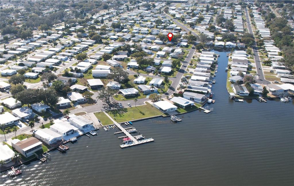 An aerial view shows a waterfront mobile home community with a red location marker — 55 LEXINGTON COURT UNIT 12, PALM HARBOR, FL
