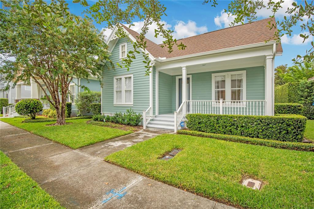 A light green, single-story house with a front porch and white trim sits on grass — 4041 HAWS LANE, ORLANDO, FL