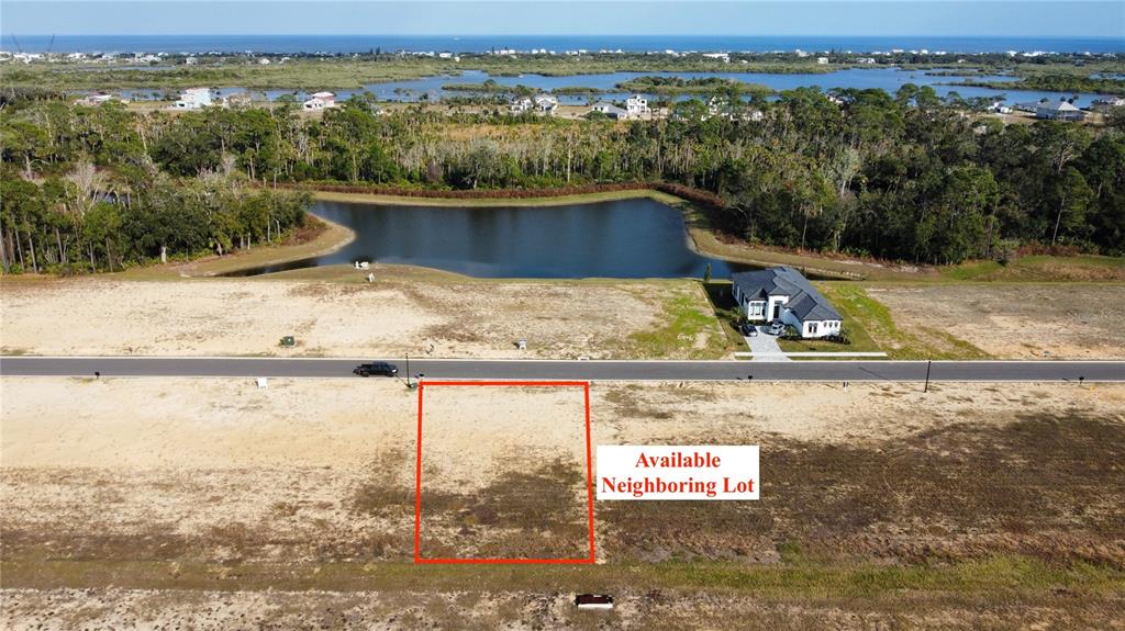 An aerial view shows a vacant rectangular lot outlined in red next to a road — 199 STILLWATER DRIVE, FLAGLER BEACH, FL