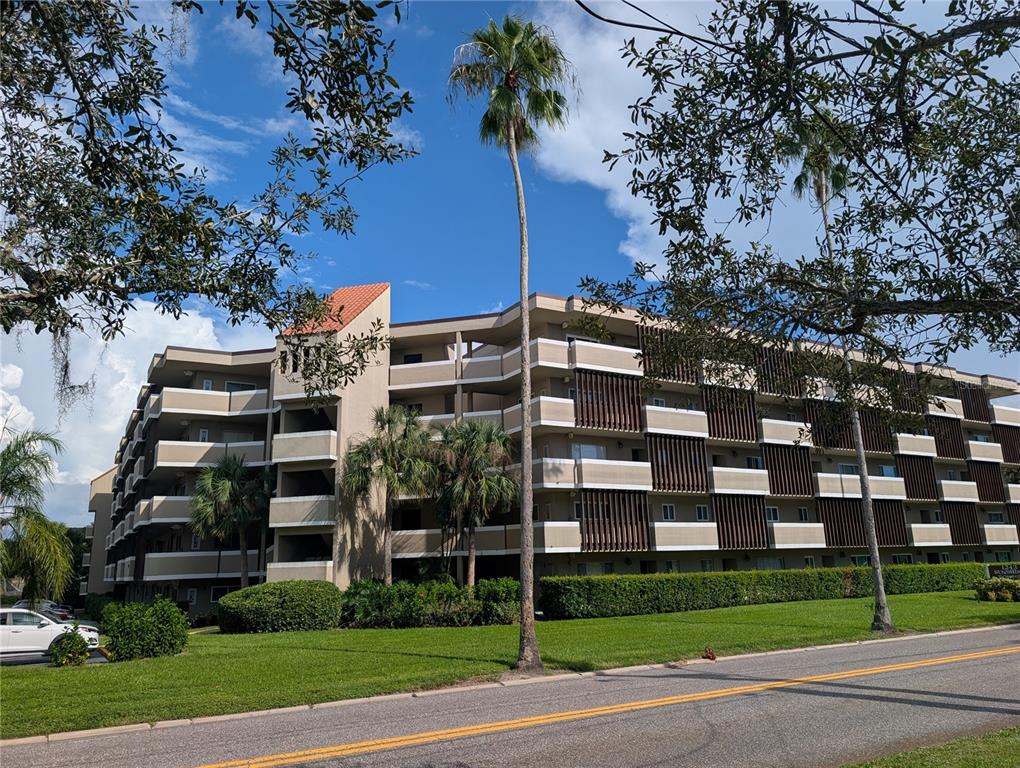 A swimming pool area is surrounded by a black fence and multi-story apartment buildings — 1243 S MARTIN LUTHER KING JR AVENUE UNIT B205, CLEARWATER, FL