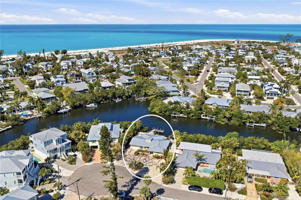 An aerial view shows a waterfront house with a private dock and a swimming pool — 109 TERN DRIVE, ANNA MARIA, FL