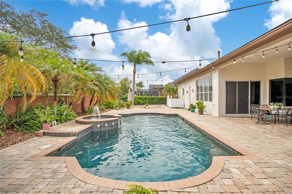 A single-story house with a white exterior, blue shutters, and a landscaped front yard — 1623 CONWAY ISLE CIRCLE, BELLE ISLE, FL