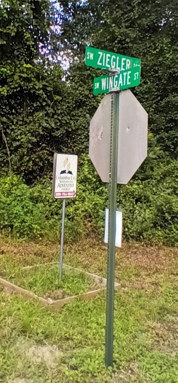 A street sign for SW Ziegler and SW Wingate stands beside a church sign — TBD UNASSIGNED, LAKE CITY, FL