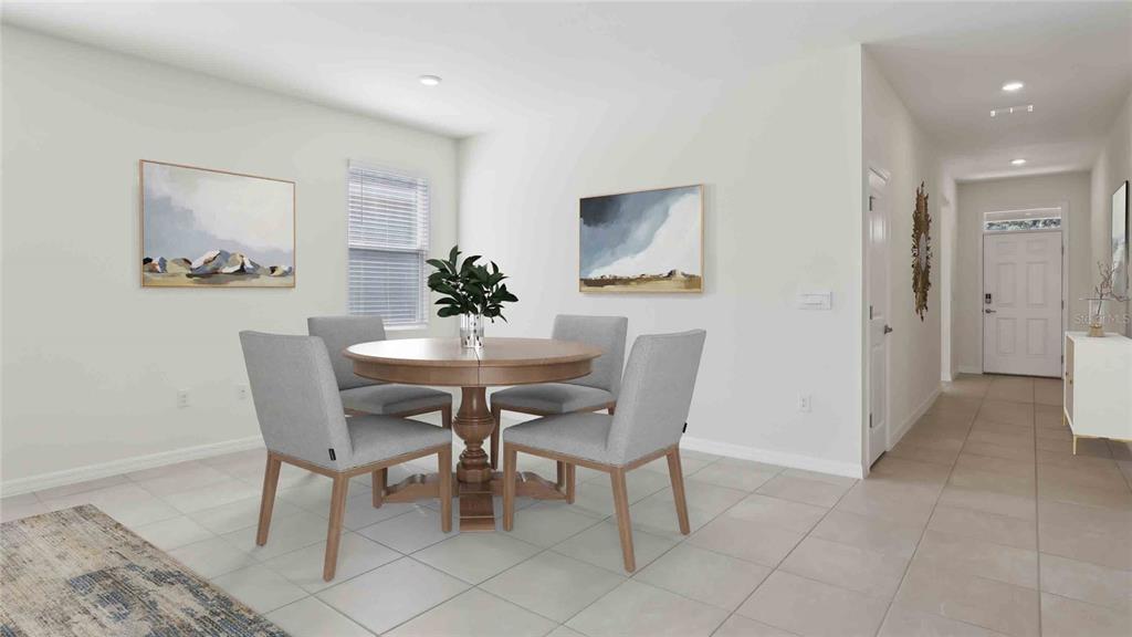 A dining area with a round wooden table, four grey chairs, and tiled flooring — 4530 NW 39TH STREET ROAD, OCALA, FL