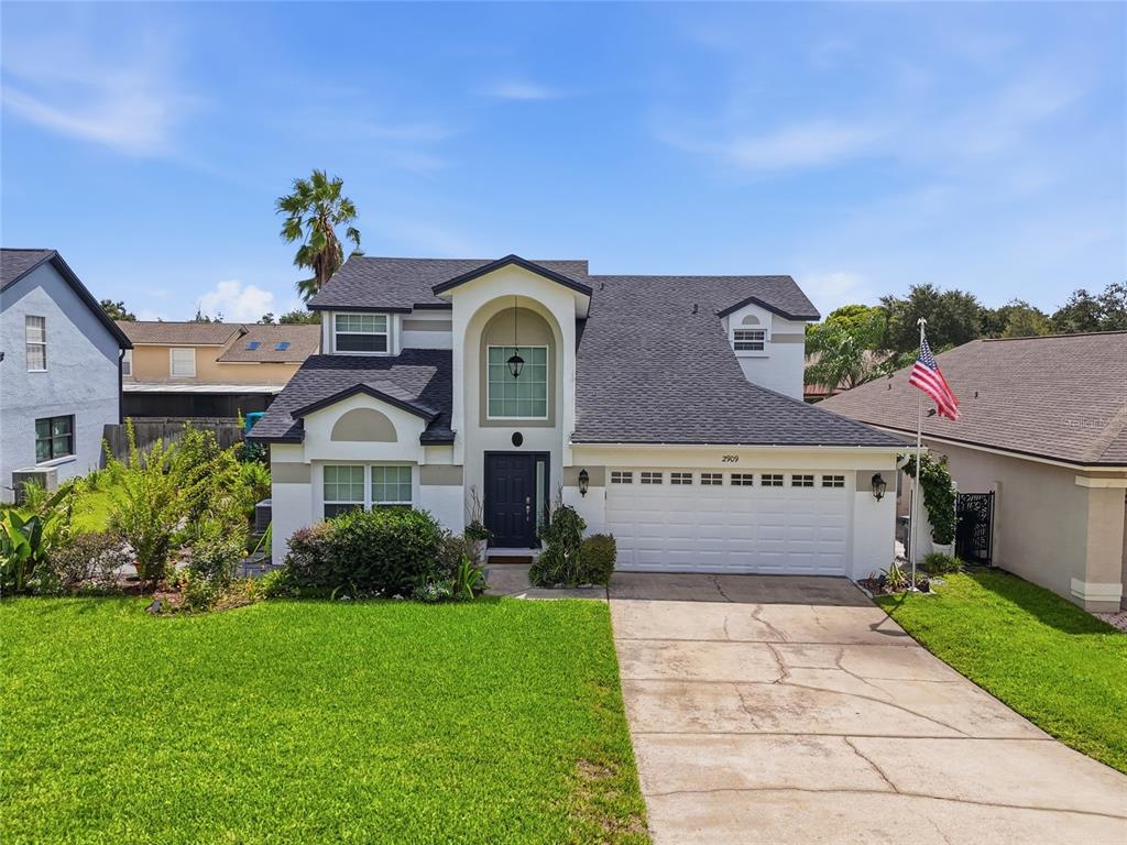 A two-story house with a white exterior, dark roof, and a two-car garage — 2909 SOMERSWORTH COURT, ORLANDO, FL