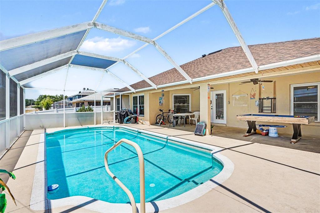 A single-story house with a beige brick facade, a two-car garage, and a white fence — 113 SHADDOCK DRIVE, AUBURNDALE, FL