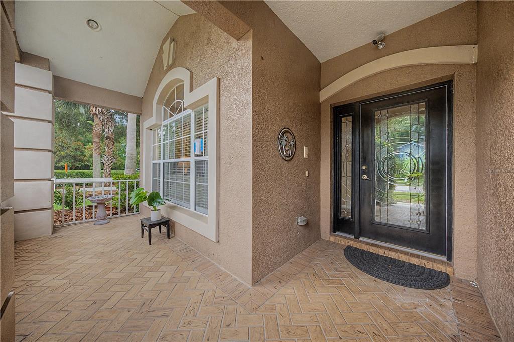 An aerial view shows a suburban house with a brown roof and palm trees — 8711 PRESTON WOODS COURT, LAND O LAKES, FL