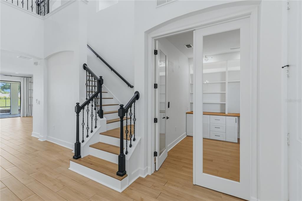 A two-story house with a paver driveway, stone accents, and a three-car garage at dusk — 5785 SAYBROOK CIRCLE, SANFORD, FL