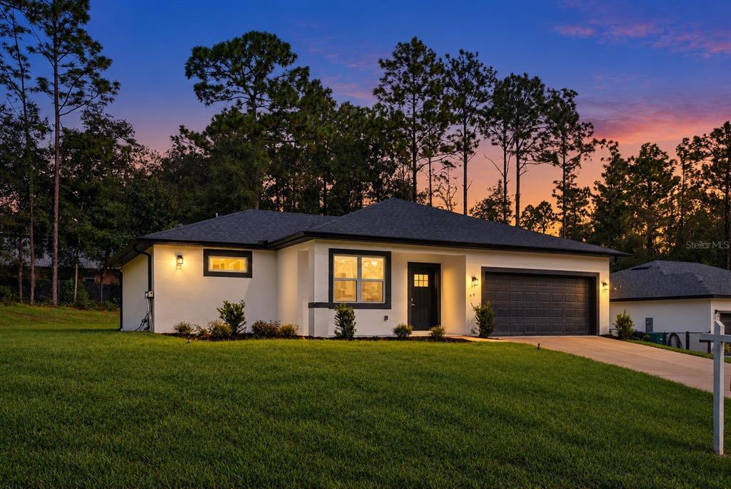 A living room with a sofa, armchairs, and a dining area in an open floor plan — 99 W GOLDCOAST PLACE, DUNNELLON, FL