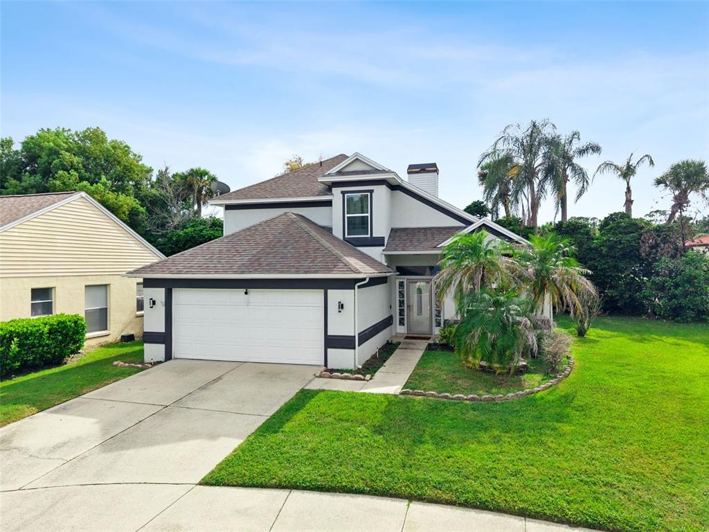 A two-story house with a white exterior, dark trim, a two-car garage, and a front lawn — 3408 IDLEGROVE COURT, ORLANDO, FL