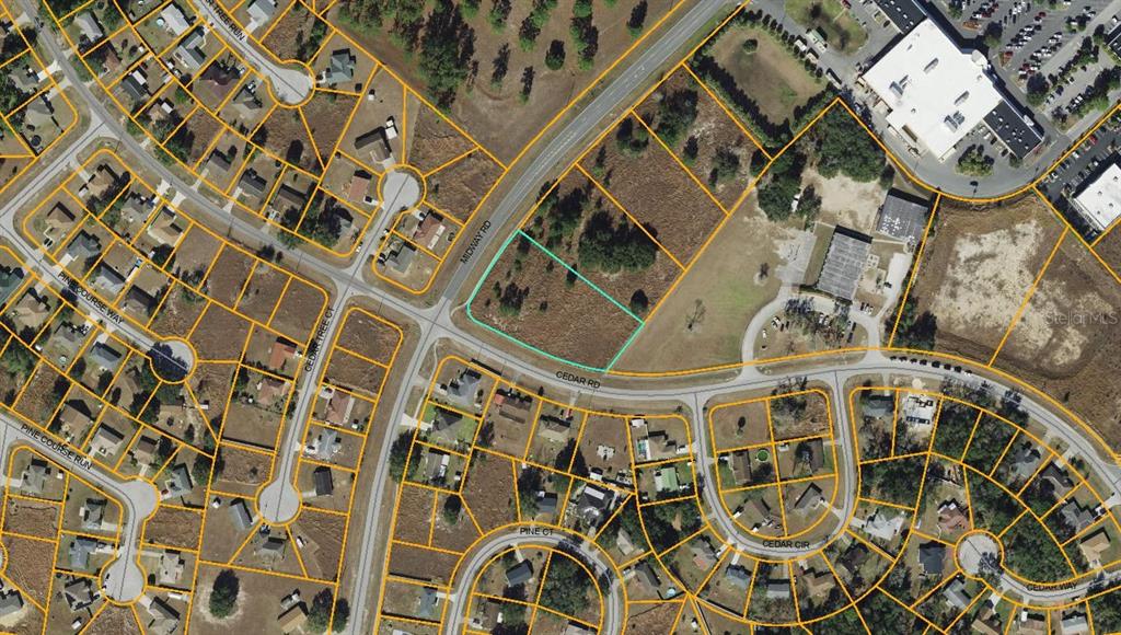 This is an aerial map showing a vacant lot outlined in teal near a road intersection — MIDWAY ROAD, OCALA, FL