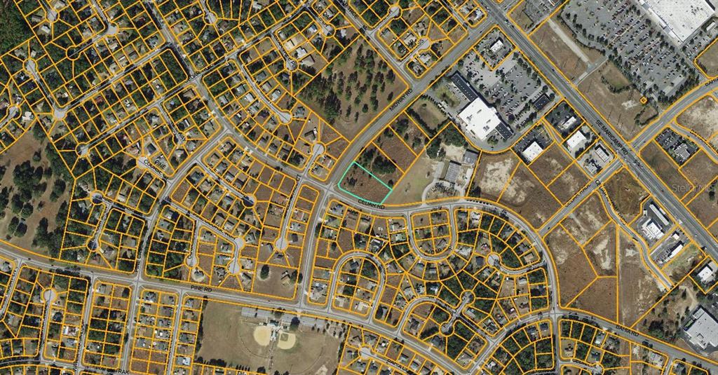 This is an aerial map showing a vacant lot outlined in teal near a road intersection — MIDWAY ROAD, OCALA, FL