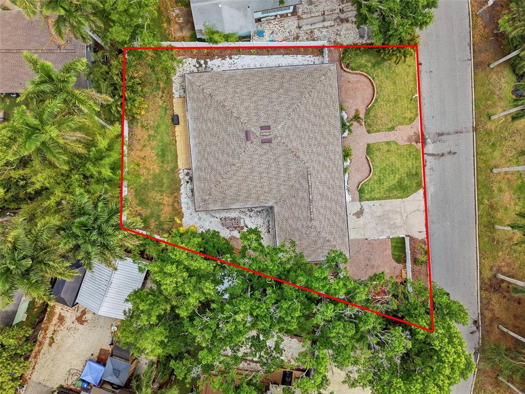 An aerial view shows a house with a shingled roof on a landscaped lot — 2004 VIRGINIA DRIVE, BRADENTON, FL