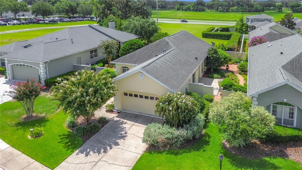 An aerial view shows three suburban houses with gray roofs and manicured lawns — 3008 SW 41ST PLACE, OCALA, FL