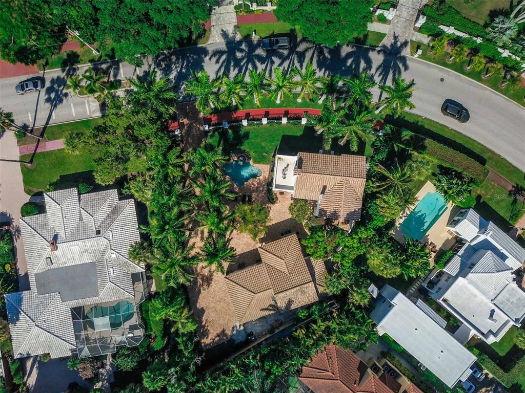 An aerial view shows several residential houses with swimming pools and palm trees — 76 S WASHINGTON DRIVE, SARASOTA, FL