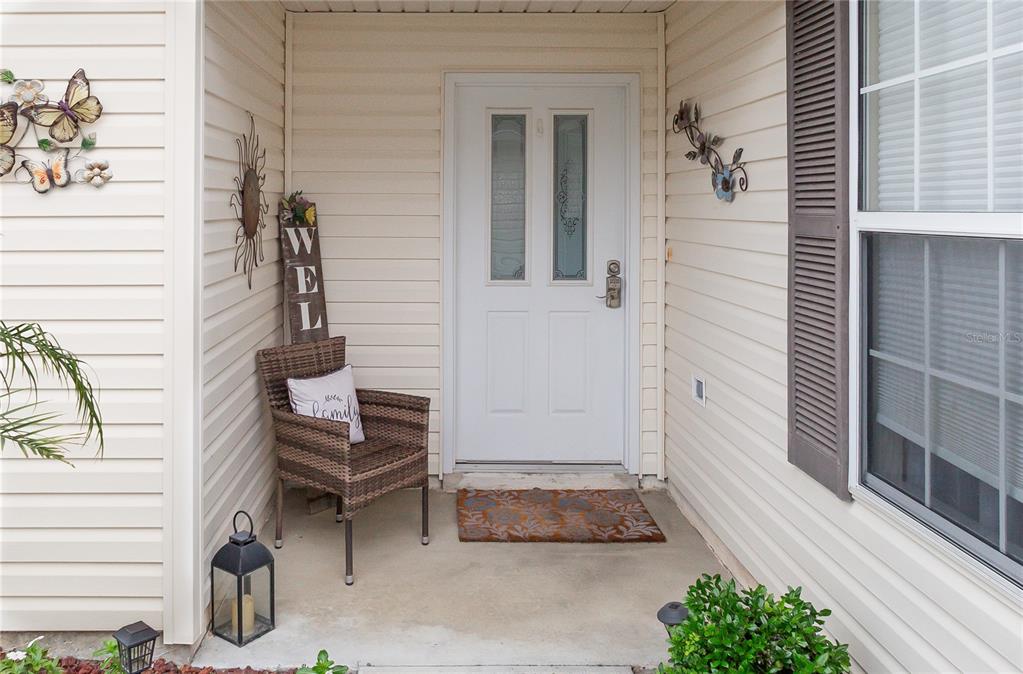 A kitchen features white cabinets, stainless steel appliances, a double sink, and tile flooring — 7618 SE 171ST SUN VALLEY PLACE, THE VILLAGES, FL