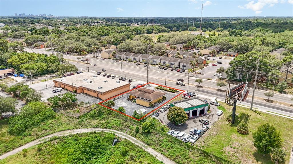 An aerial view shows a commercial property outlined in red next to a service station — 6005 SILVER STAR ROAD, ORLANDO, FL