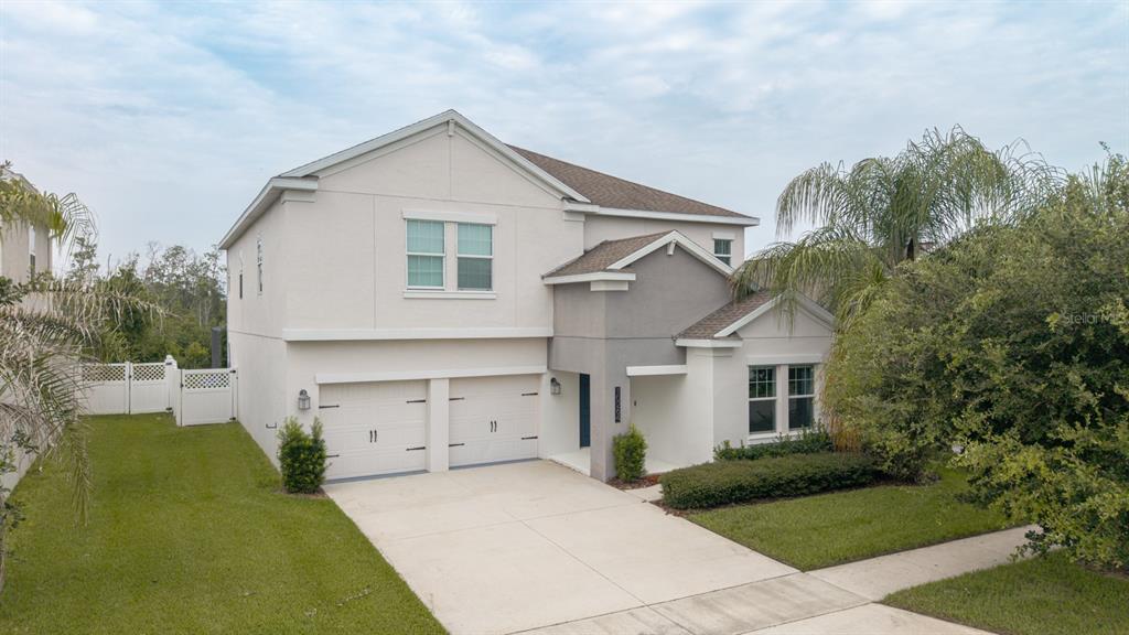 A screened-in patio features a rectangular swimming pool with lounge chairs and a covered area — 10264 LOVE STORY STREET, WINTER GARDEN, FL